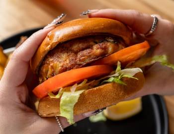 A closeup of a fish cake sandwich