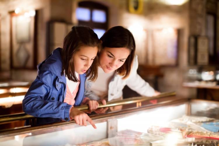 Mother and daughter looking at a museum display