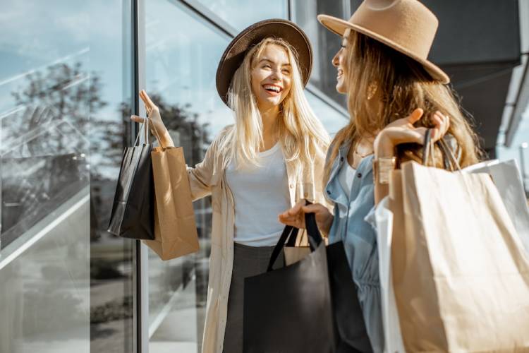 Two women carrying shopping bags