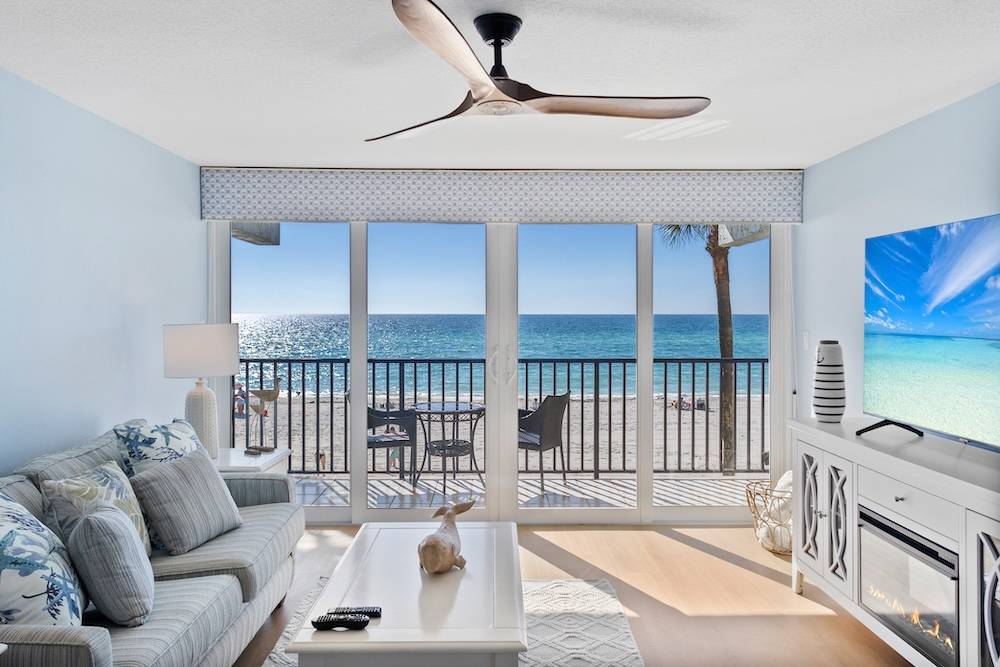 Vacation rental interior with balcony and ocean view in background